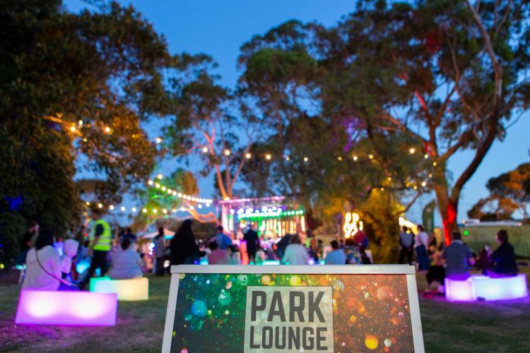 Park Lounge sign with trees and festoon lighting at dusk